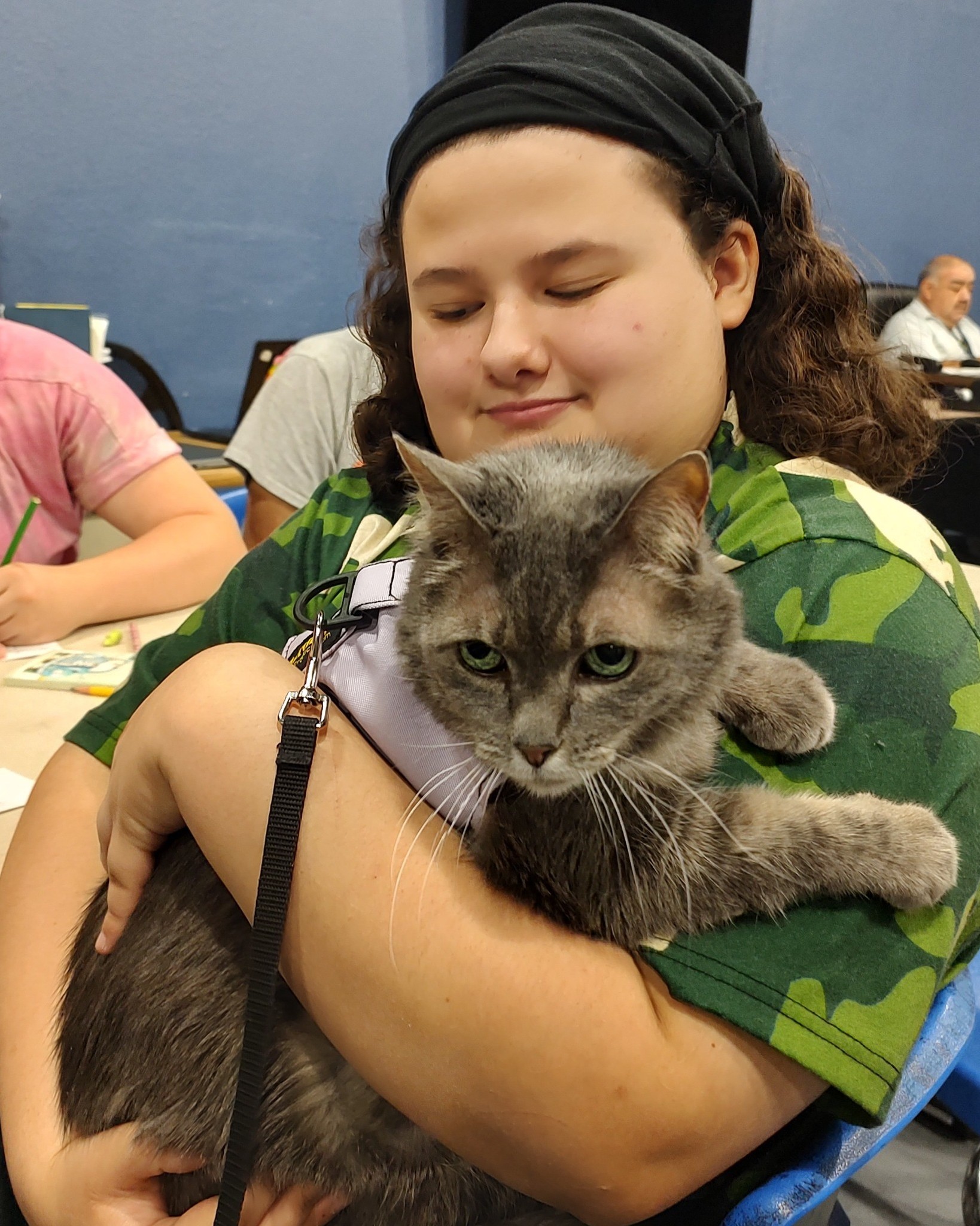 a girl holding a cat